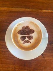 Cup of coffee served beautifully with a picture of cinnamon.