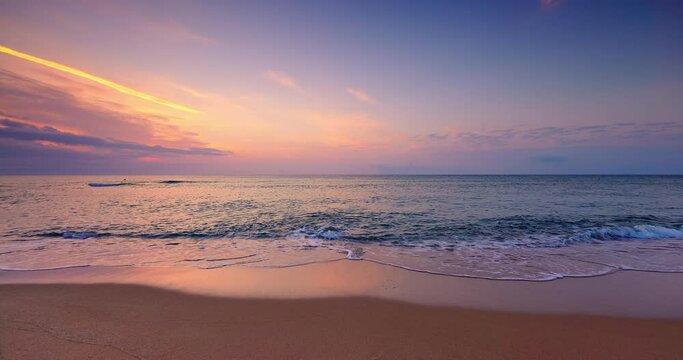 Tropical beach shore and golden sea sunrise and splashing sea waves