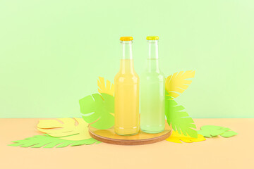 Composition with bottles of fresh soda and paper leaves on color background