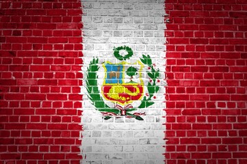 Shot of the Peru flag painted on a brick wall in an urban location