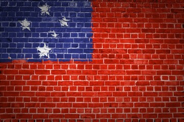 Image of the Samoa flag painted on a brick wall in an urban location