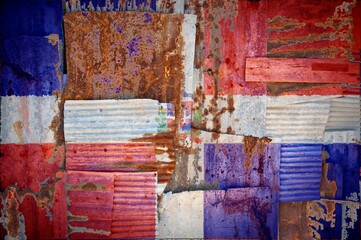 Abstract background of the flag of Dominican Republic painted on rusty corrugated iron sheets