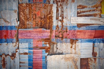 Abstract background of the flag of the Faroe Islands painted on rusty corrugated iron sheets