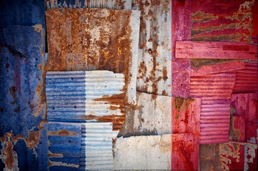 Abstract background of the flag of France painted on rusty corrugated iron sheets