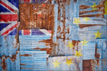 Flag of Tuvalu painted onto rusty corrugated iron sheets overlapping to form a wall or fence