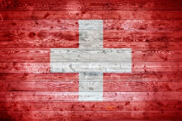 Illustrative flag of Switzerland on a wooden surface
