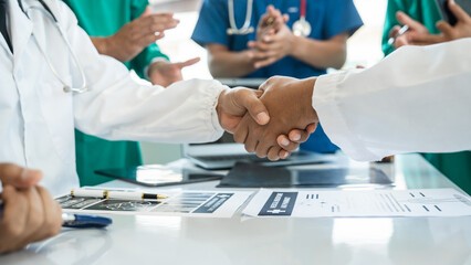 Shaking hands of International doctor team meeting hospital medical staff.