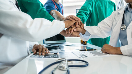 Stack of hands of International doctor team meeting hospital medical staff.