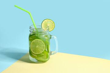 Mason jar of cold mojito on colorful background