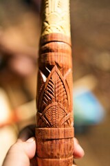 Vertical closeup of the carving on a blowpipe