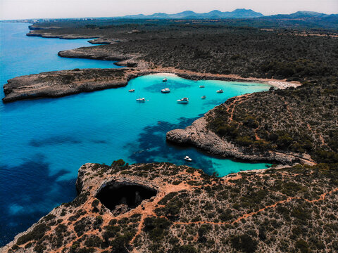 Beautiful drone view of the beach Cala Varques with boats on Mallorca