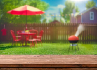 summer time in backyard garden with grill BBQ, wooden table, blurred background