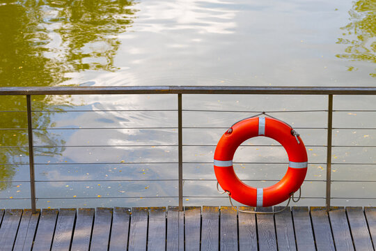 red lifebuoy on the pier without people
