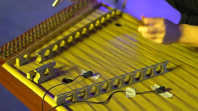 checking hammered dulcimer for playing music closeup view