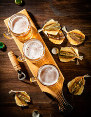 Glasses of beer with dried fish.