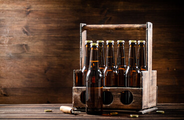Obraz na płótnie Canvas Beer bottles in an old box.
