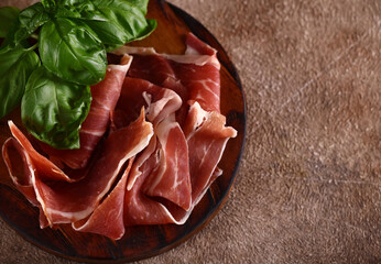 organic parma ham dry cured jamon on a wooden board