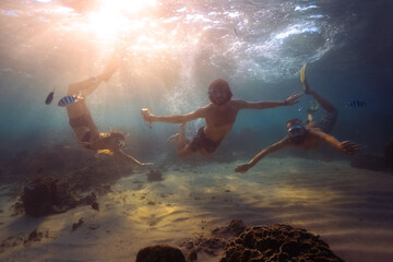 Young friends snorkeling and having fun in a tropical sea.