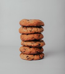 Closeup of stacked chocolate cheap cookies on gray background