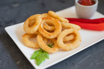 fast food breaded onion rings fried with sauce