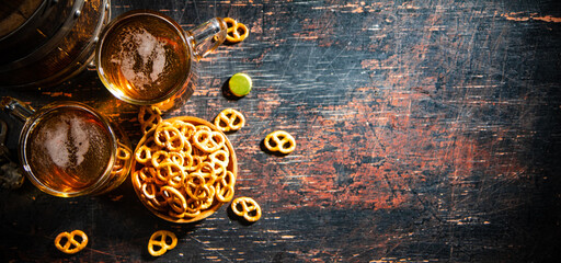 Beer in glasses with salted pretzels.