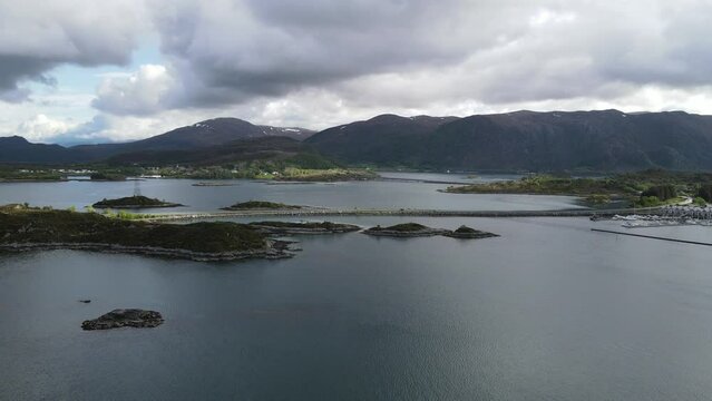 View of the Norwegian Sea and Heroy Bridge with mountains in the background. Norway.