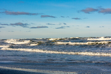 Waves, sea and beach (Baltic Sea coast) with blue sky and clouds
