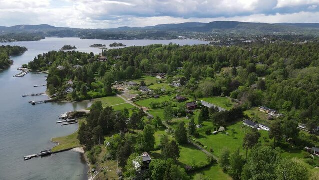 4k aerial footage of the sea and green shore. Bronnoya, Norway.
