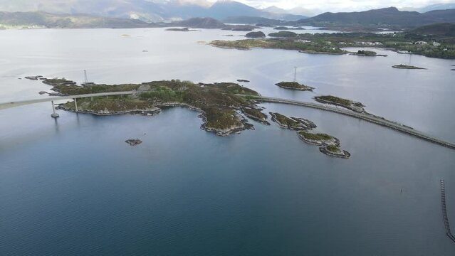 View of the Norwegian Sea and Heroy Bridge with mountains in the background. Norway.