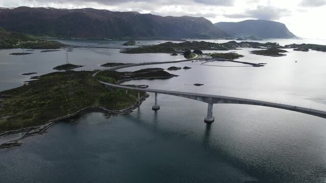 View of the Norwegian Sea and Heroy Bridge with mountains in the background. Norway.