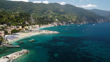 Fototapeta na wymiar Aerial drone shot of a blue sea in the town of Monterosso al Mare, La Spezia, Italy