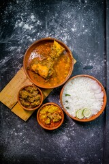 Top view of white rice with lime and other meals on a wooden board on the kitchen table