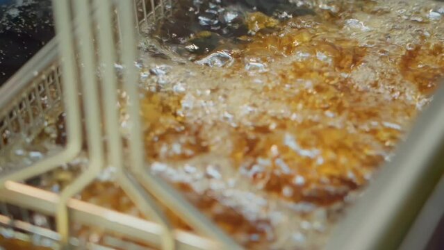 Closeup shot of food cooking in a deep fryer in a restaurant