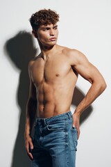 Fototapeta premium man sport jeans standing athlete beauty strong gray background fitness lifestyle