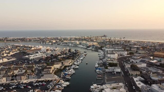 Aerial shot of Newport Beach with boats on the water and buildings in the background