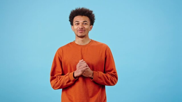 Guilty black guy rubs hands nervously and shrugs shoulders