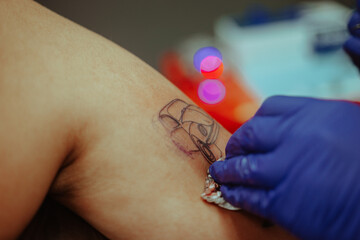 Close up of cleaning a tattoo