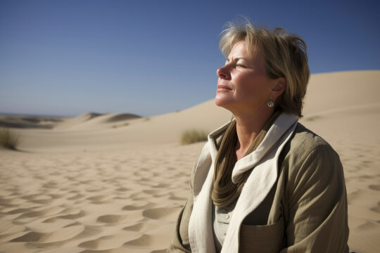 Mature woman in the middle of the desert, looking at the horizon
