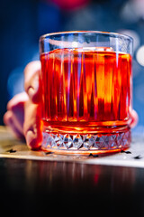 man hand bartender hold cocktail glass in bar