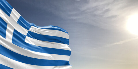 Greece national flag cloth fabric waving on beautiful grey sky Background.