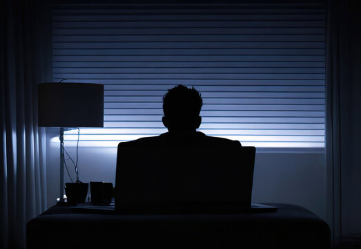 ai generated silhouette of a person working on his desk facing a window, dark scary mood 