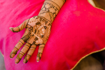 Artist applying henna tattoo on women . Mehndi is traditional Indian decorative art. Close-up