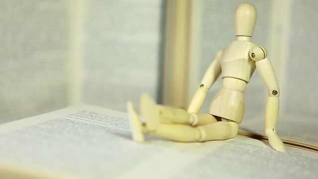 footage of blur wooden mannequin book 