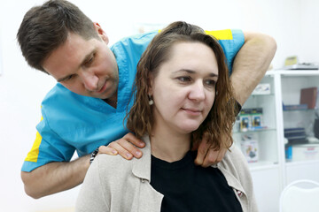 Osteopath relieves pain in neck region of patient