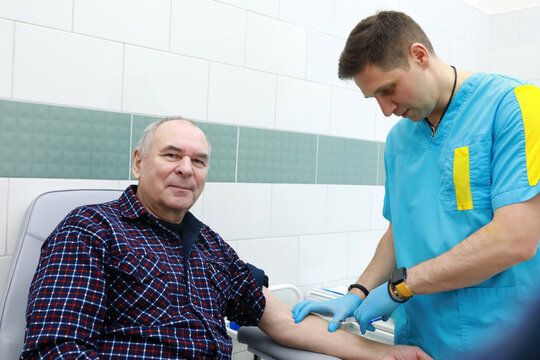 Doctor takes blood from senior man