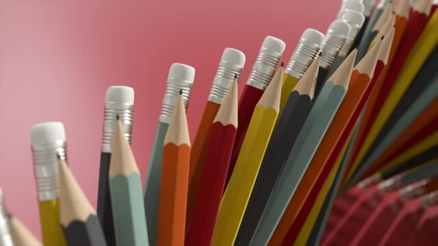 Ads concept. Stationery. Top view of pencils arranged vertically and moving along the conveyor. Eraser on a pencil