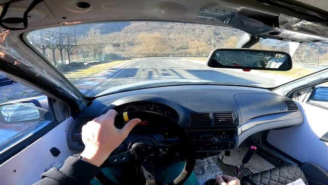 Extreme sport drifting on racing playground, skilled driver doing dangerous maneuvers and techniques steering wheel and changing gears, view from inside of drift car, sports entertainment and