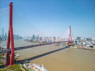 The drone aerial view of Yangpu bridge and Huangpu River in Shanghai, China. 