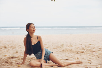 Fototapeta na wymiar woman vacation sea freedom beach sitting hair sand travel long nature smile