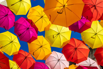 Fototapeta na wymiar Colorful Umbrellas Hanging As Street Decoration And Sun Protection In The City Of Bordeaux, France